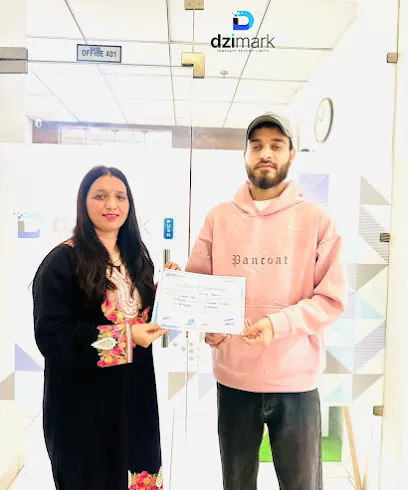 A Dzimark student holding a certificate of completion at the Dzimark office